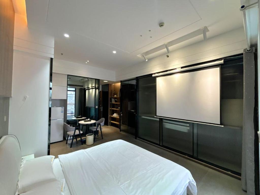 Postel nebo postele na pokoji v ubytování Zhongshan Perth Hotel Apartment - Shiqi Wanxianghui Branch