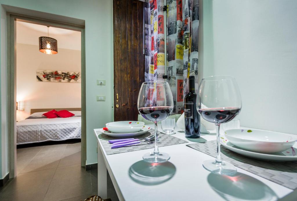 two wine glasses sitting on a table in a room at Casetta Venere in Castellammare del Golfo