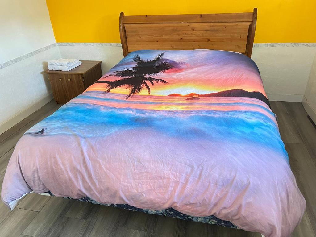 a bed with a painting of a beach with a palm tree at Surrey central house in Surrey