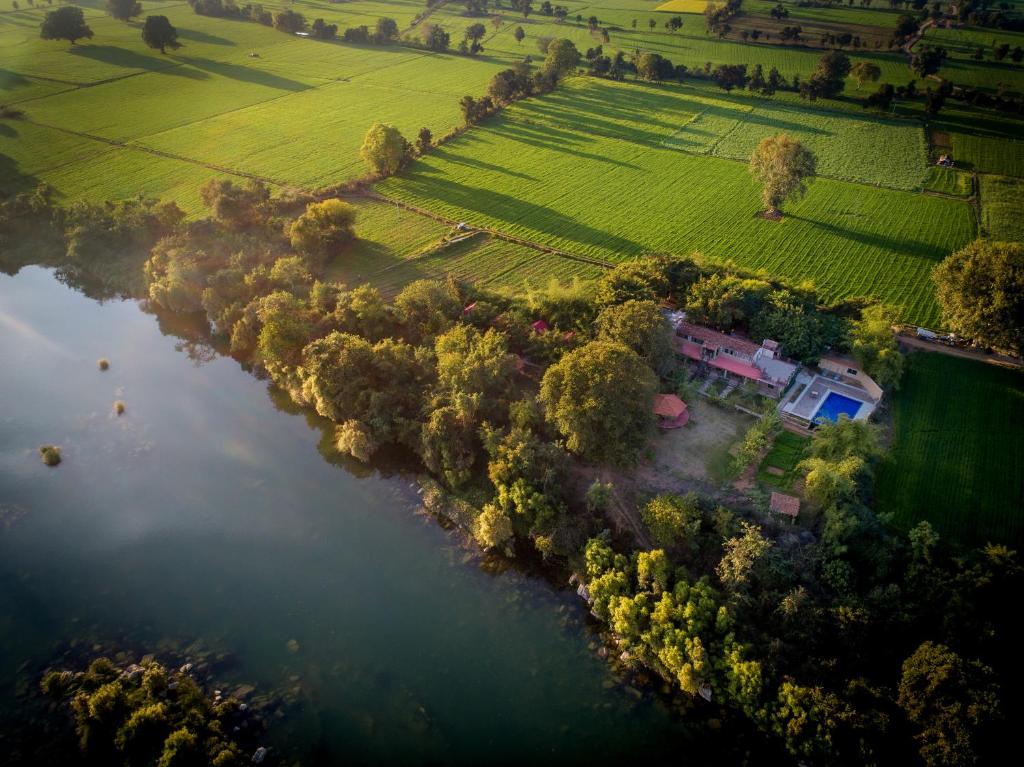 an aerial view of a house next to a river at Greetoe Camp Panna in Khajurāho