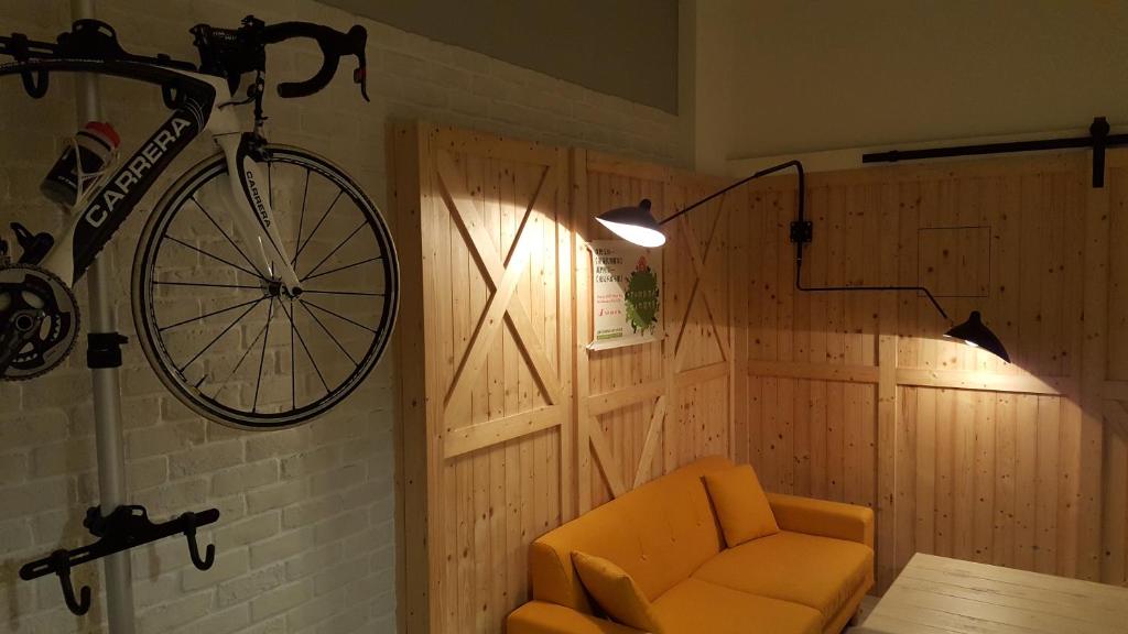 a bike hanging on a wall next to a chair at Daybreak in Taitung City