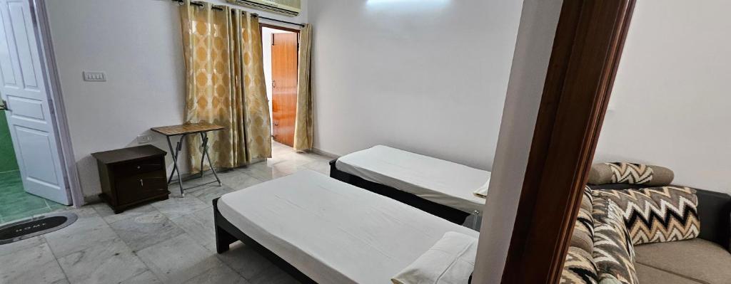 a hospital room with two beds and a fireplace at Prashanth kuteer in Hyderabad