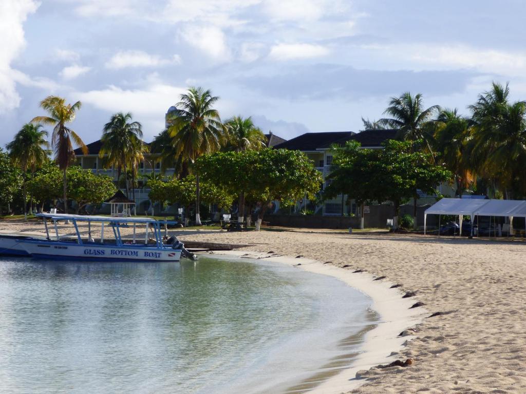 a boat is docked on the shore of a beach at Beach Studio 30 in Ocho Rios