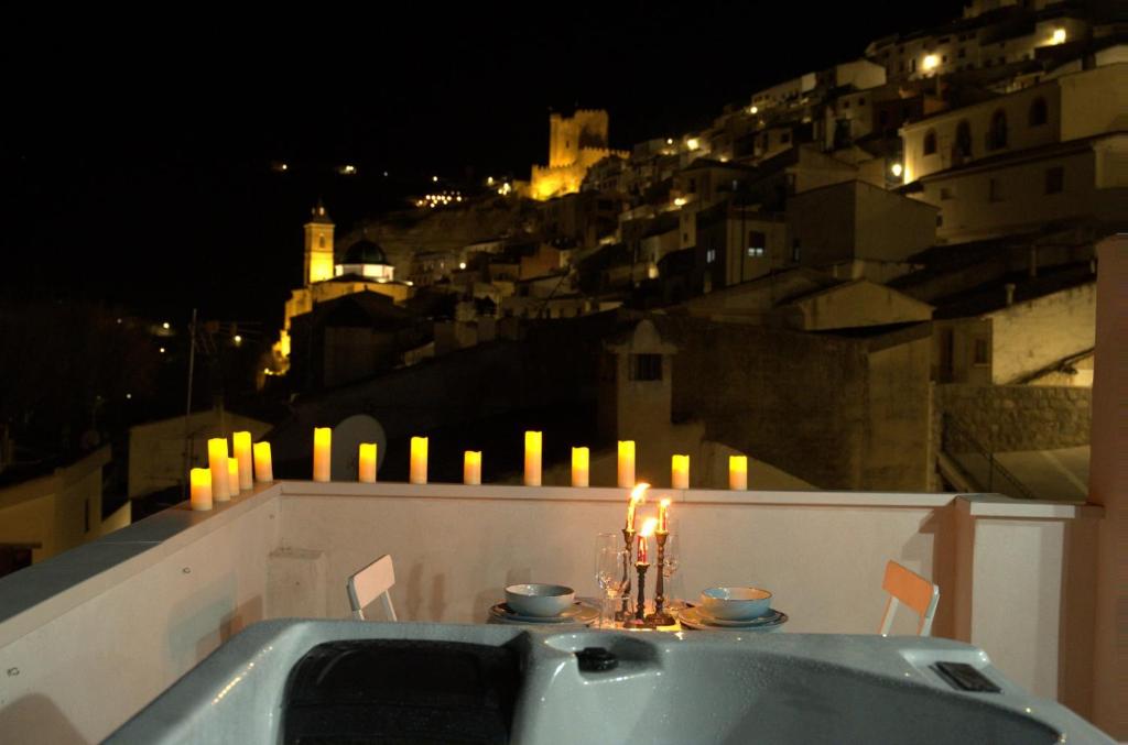a bath tub sitting on top of a balcony with candles at Tahona Ático - Gaiamoment in Alcalá del Júcar