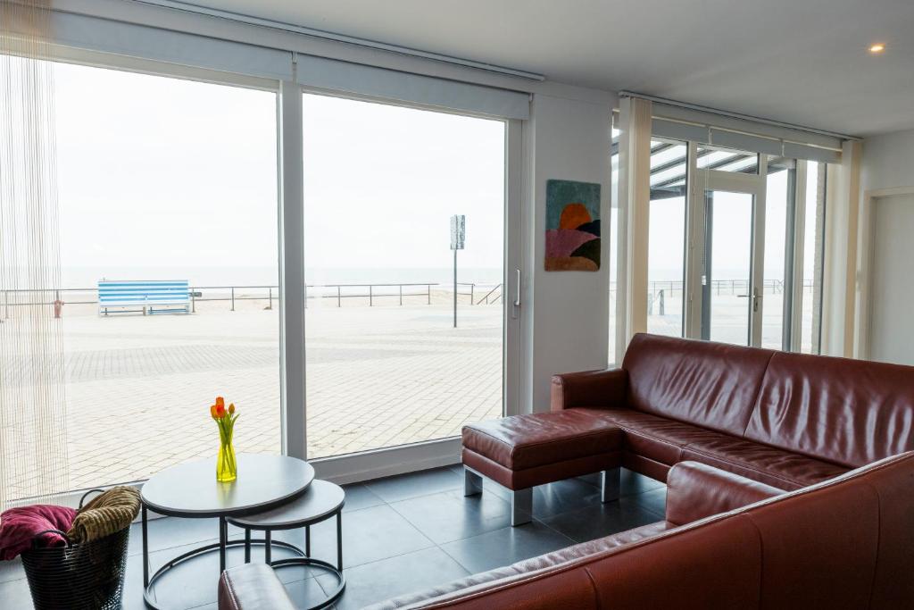 a living room with a couch and a table at Zeedijk 237 Middelkerke in Middelkerke