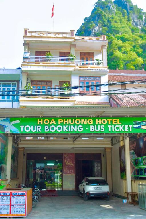 a hotel with a sign in front of a building at Hoa Phuong Hotel Phong Nha in Phong Nha