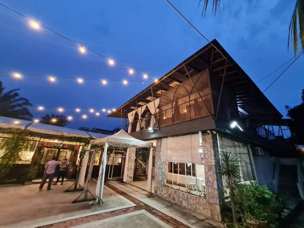 a couple standing outside of a house at night at Bangi Guest House, Bangi Lama in Kajang