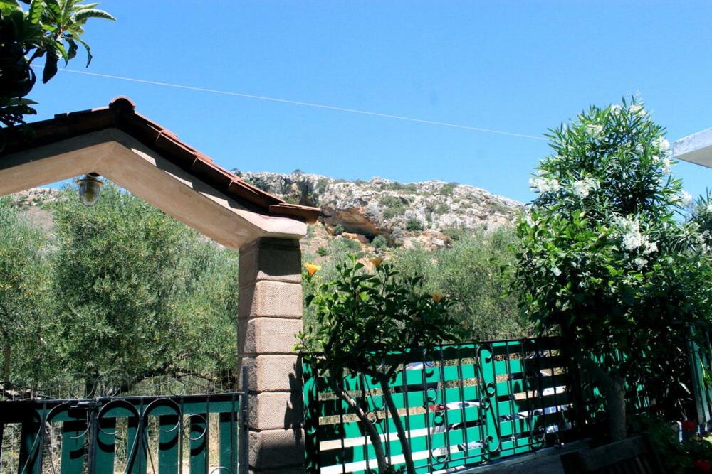 a green gate with a mountain in the background at Village Villa Marika Drapanias in Drapaniás