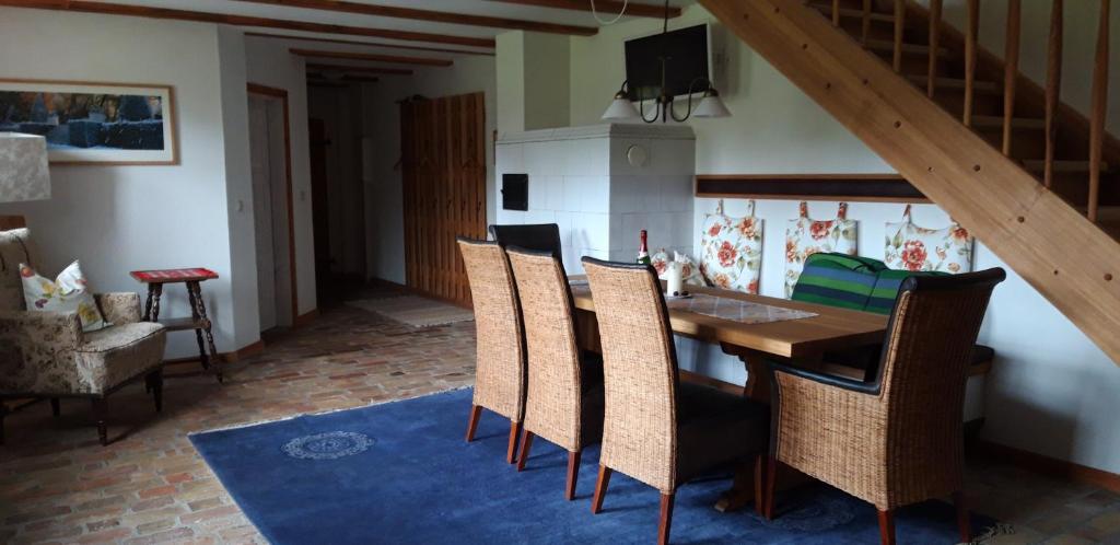 a dining room with a wooden table and chairs at 160 qm große Ferienwohnung für 5 Personen nahe Stettiner Haff in Bugewitz