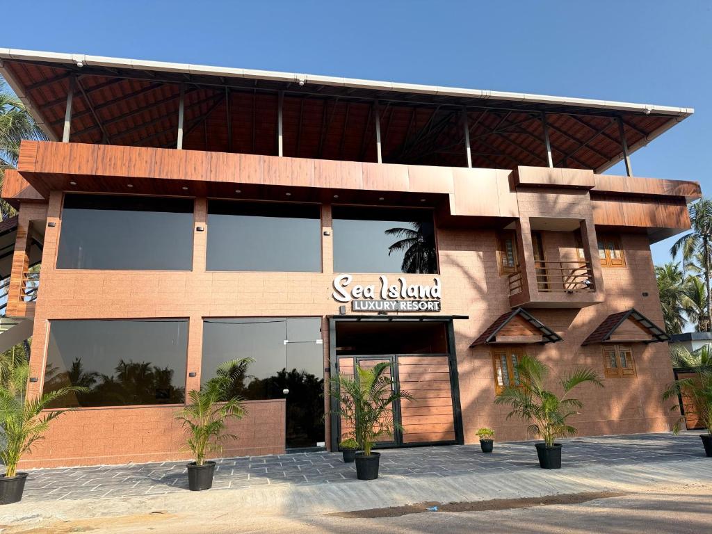 a building with a sign that reads scar island ultimate resort at Sea Island Resort in Cheruvattūr