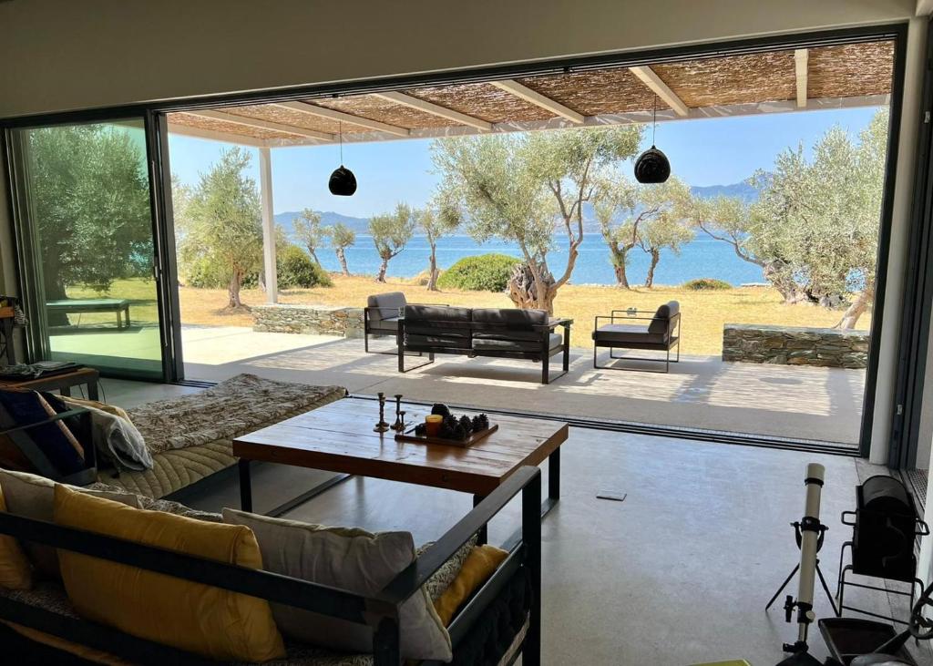 a living room with a large sliding glass door at VILLA PORT OLIVIER in Alyfantá