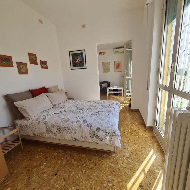 a bedroom with a bed in a white room at L' attichetto in Rome