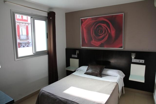 Posteľ alebo postele v izbe v ubytovaní Hostal Central