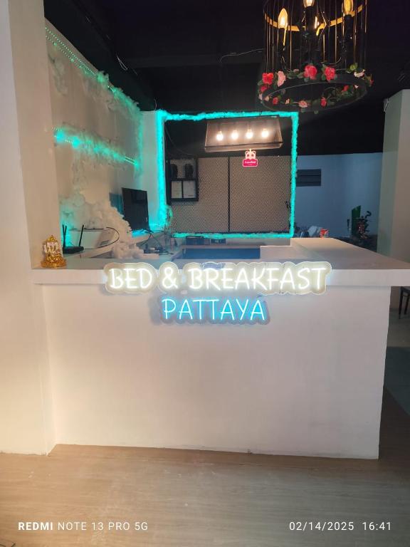 a white counter in a room with blue lights at Bed & Breakfast Pattaya in Pattaya