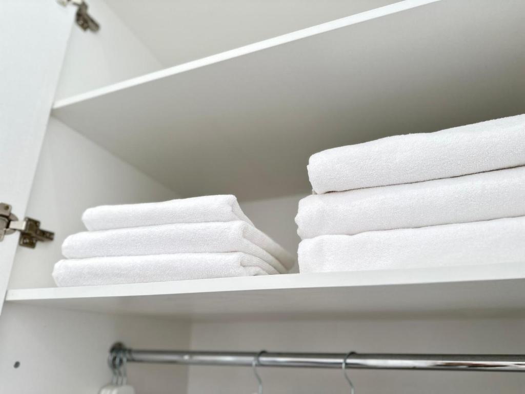 a stack of towels on a shelf in a bathroom at Apartment Bay Tash Tower in Bishkek
