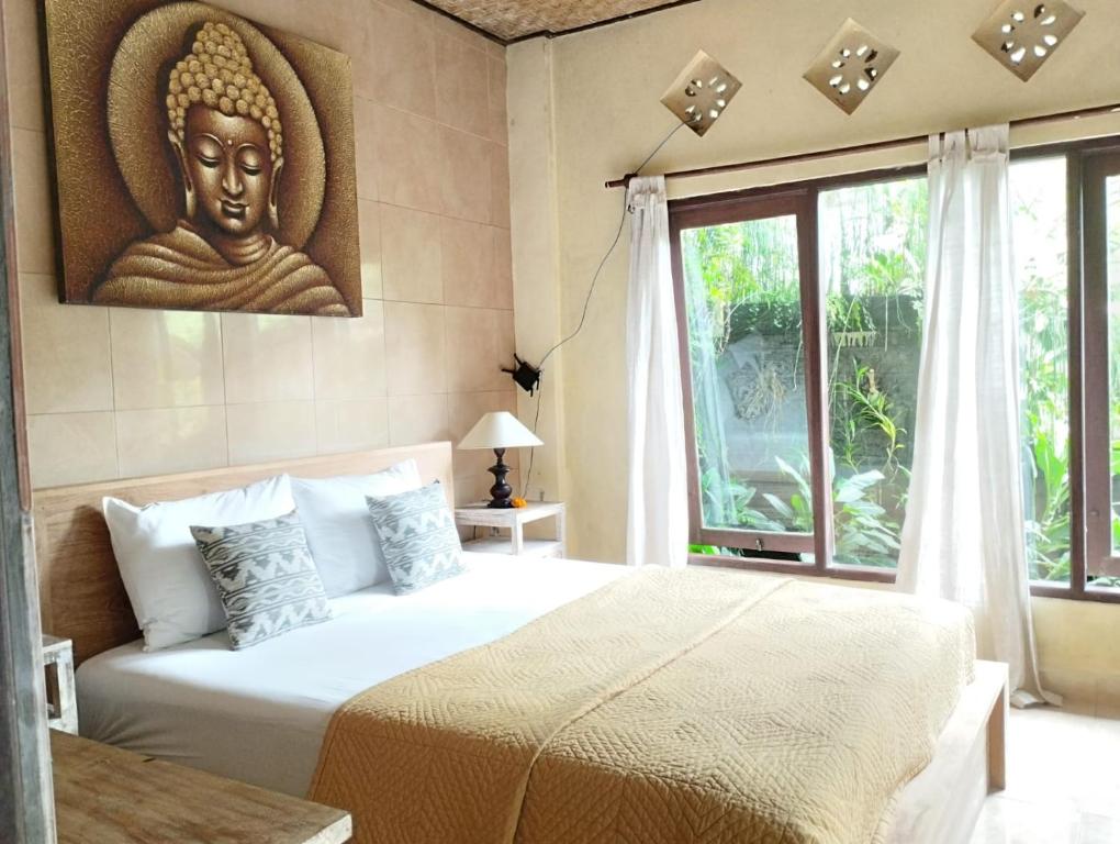 Postel nebo postele na pokoji v ubytování Umah Ubud Guest House