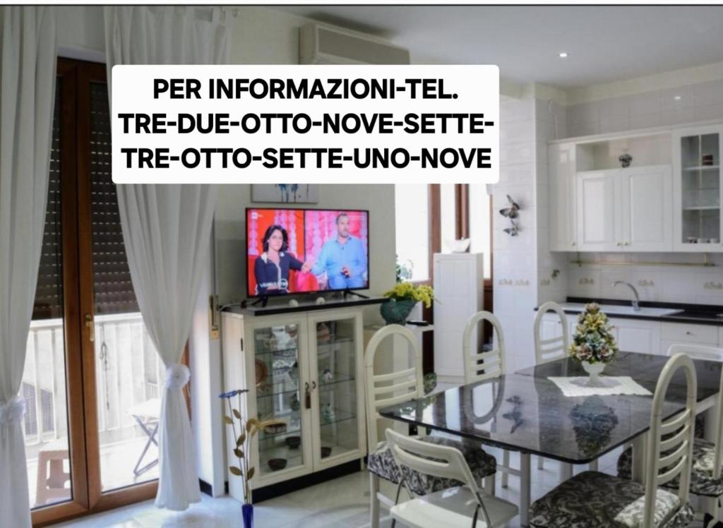 a kitchen with a table and a tv in a room at Residenza Margherita - Centralissima in Salerno