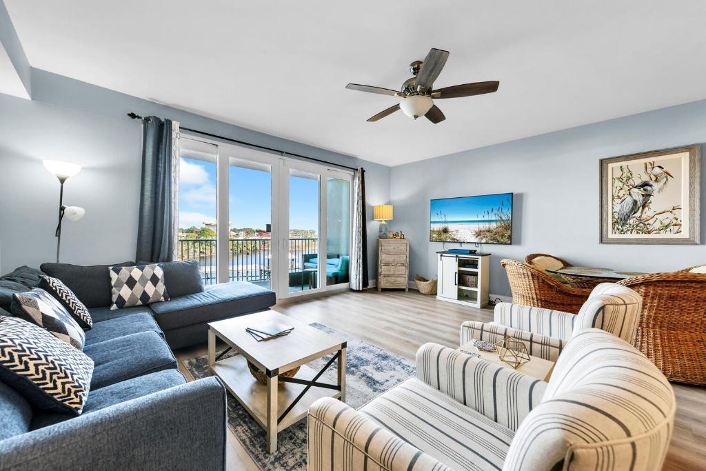 a living room with a couch and a ceiling fan at Laketown Wharf 317 in Panama City Beach