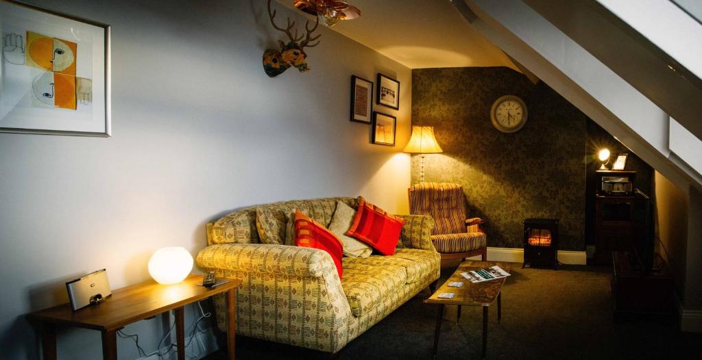 a living room with a couch with red pillows at Docker's Digs in Gateshead