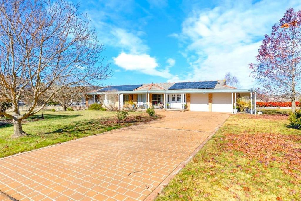 a house with solar panels on the roof at Marrangaroo Meadows in Marrangaroo