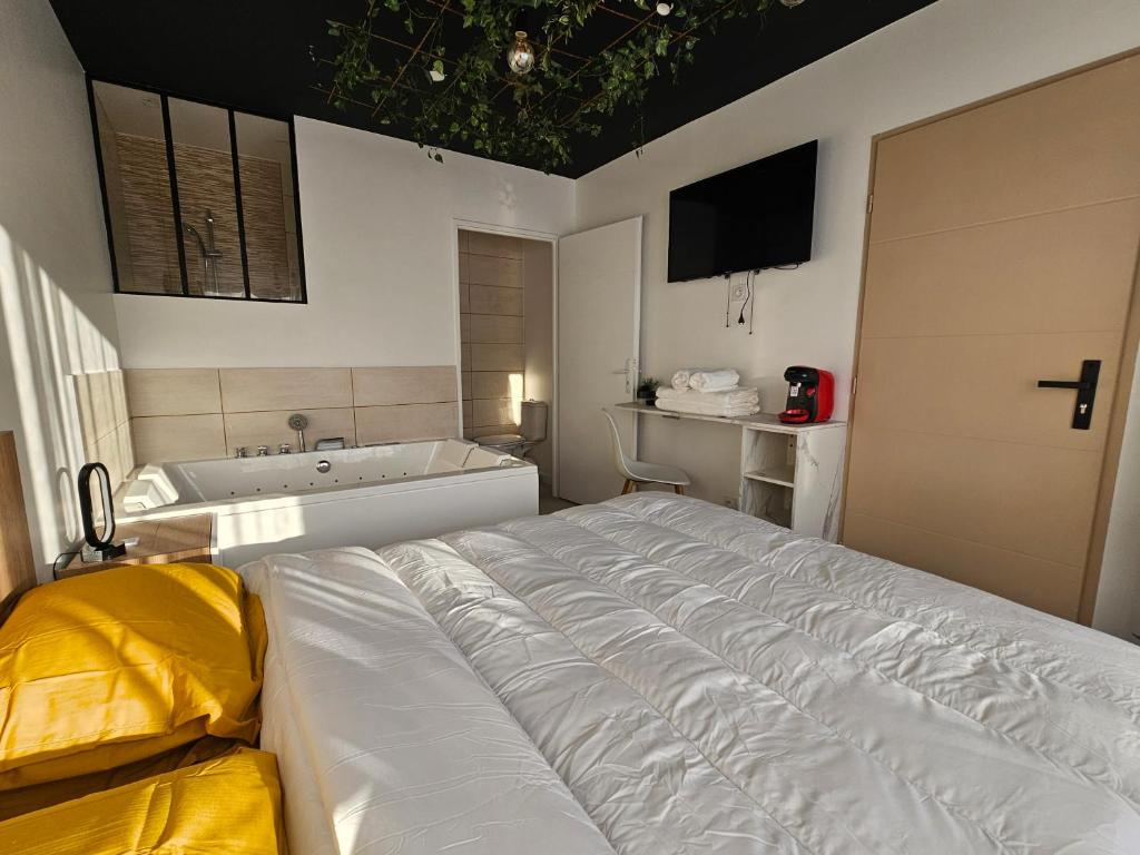 En eller flere senge i et værelse på Evasion balneo