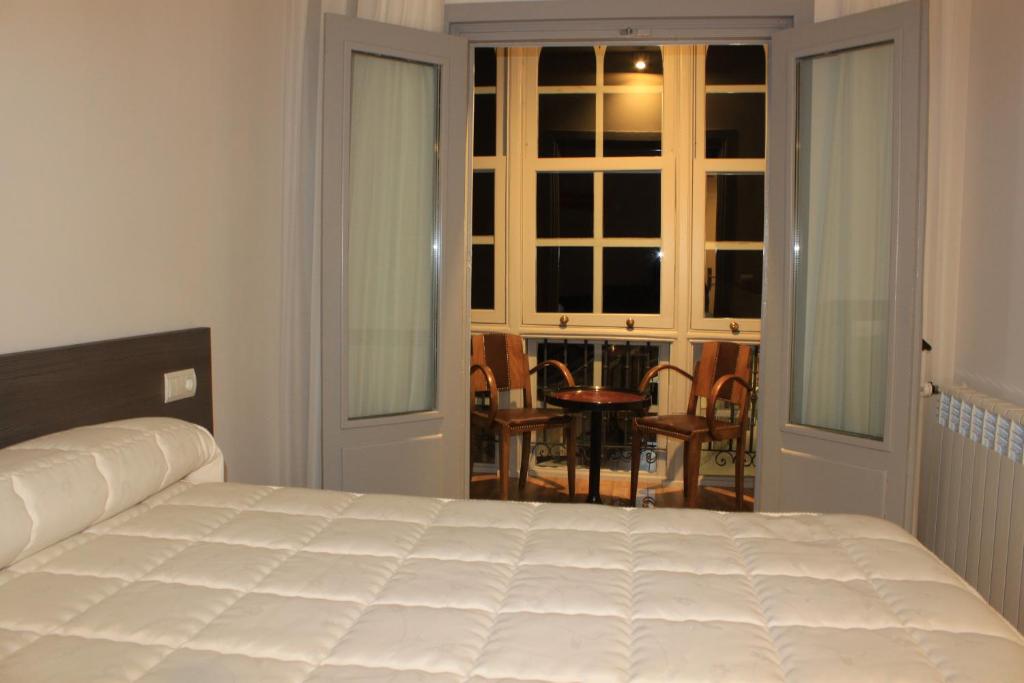 Postel nebo postele na pokoji v ubytování Hostal Siglo XIX