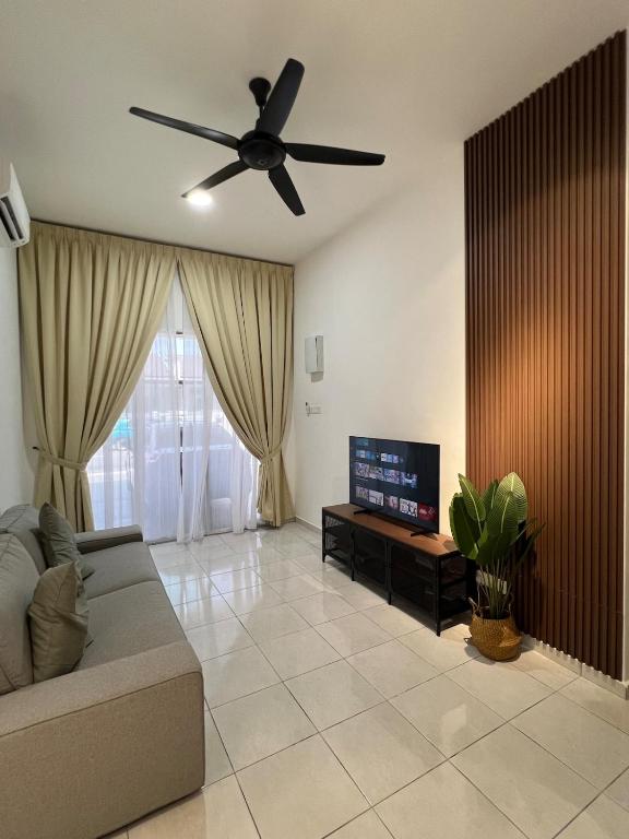 a living room with a couch and a ceiling fan at Rumavin Homestay, Seremban in Seremban
