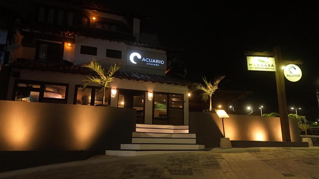 a building with a sign on it at night at Acuario Pousada in Arraial do Cabo