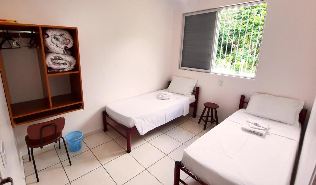 Postel nebo postele na pokoji v ubytování Eventos e Hospedagem São José
