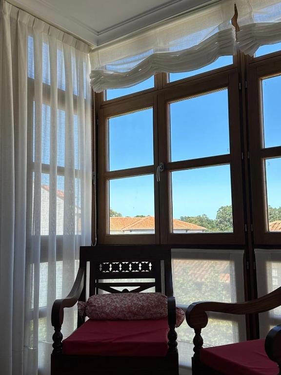 a room with a window with a bench in front of it at Cuevas del Mar in Nueva de Llanes