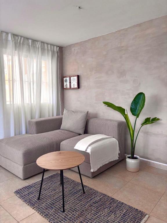 a living room with a couch and a table at Playa de Miramar - 3 Min Walk to the Beach, Family-Friendly, Near Gandia in Miramar