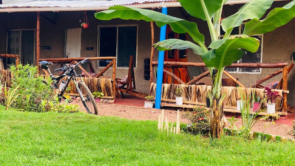 a bike parked in front of a house at Alkebulan Farm House in Moshi