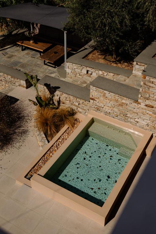 a swimming pool in the middle of a yard at Gianemma Luxury Apartments in Mylopotas