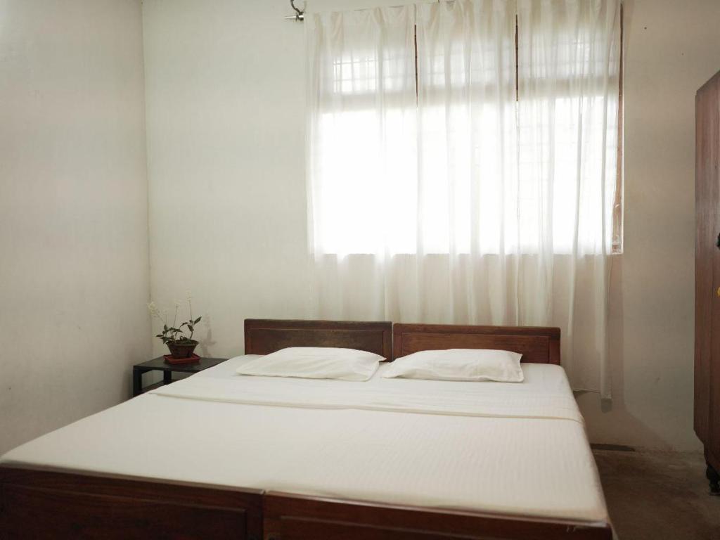 Postel nebo postele na pokoji v ubytování Amma's Homestay