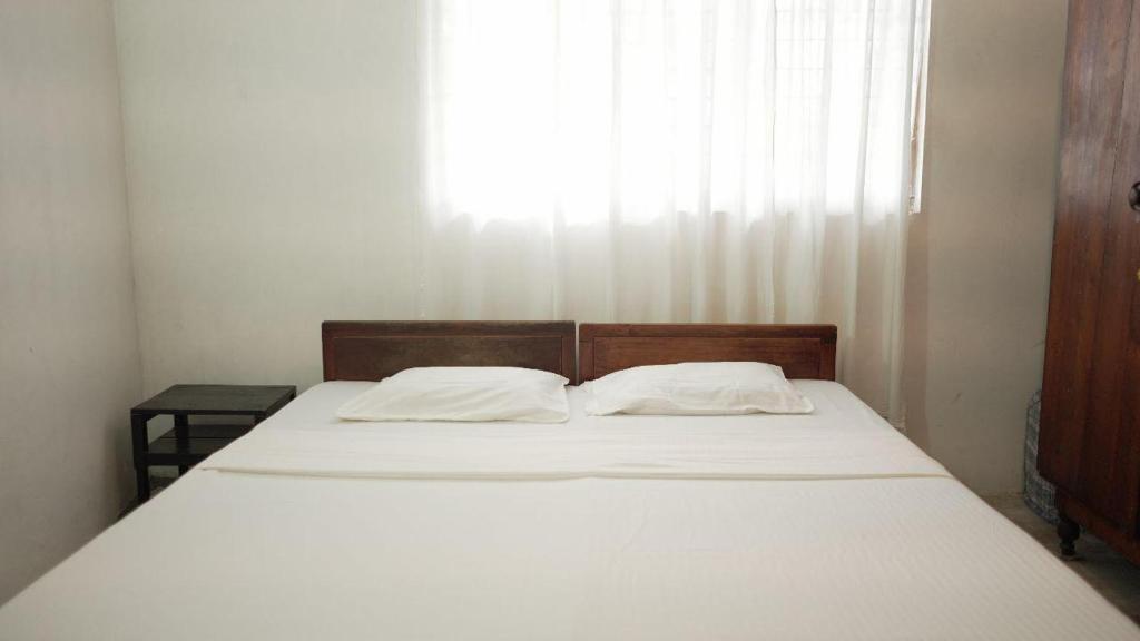 Postel nebo postele na pokoji v ubytování Amma's Homestay