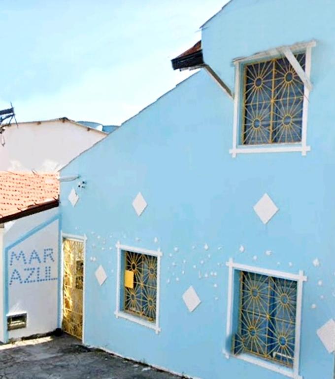 a blue building with white squares on it at pousada mar azul in Salvador