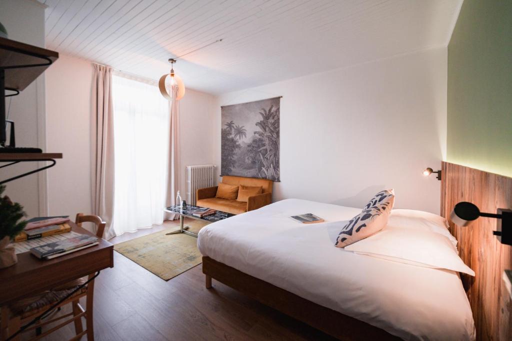Postel nebo postele na pokoji v ubytování Hôtel Maison Doron