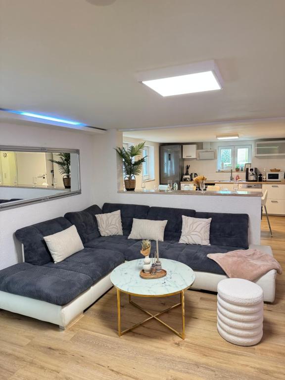 a living room with a blue couch and a table at Family & Friends Hannover 75m2, Messe in Hannover