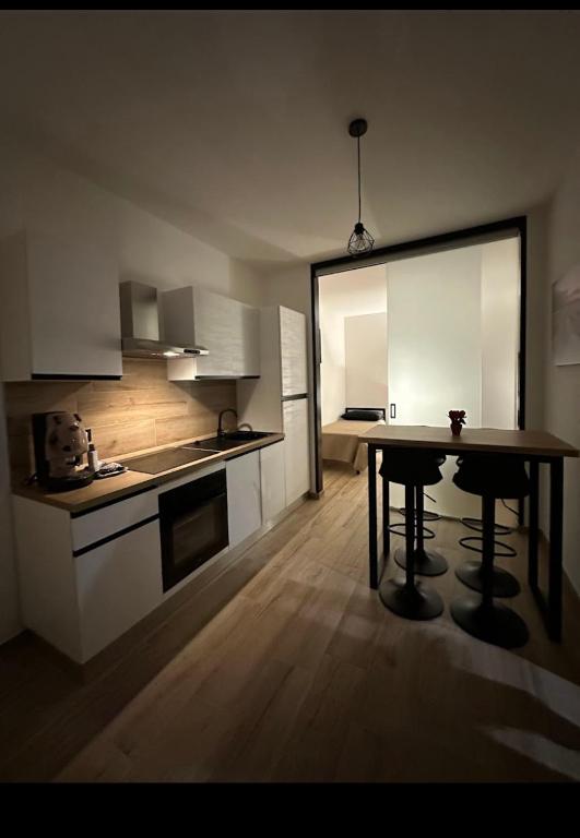 a kitchen with a table in the middle of a room at Gaia apartments in Porto Cesareo