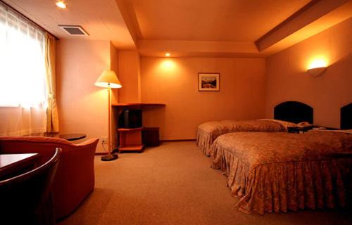 Postel nebo postele na pokoji v ubytování Hakuba Hotel Ougiya