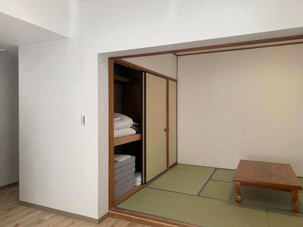 Postel nebo postele na pokoji v ubytování 軽井沢七福荘ホテル