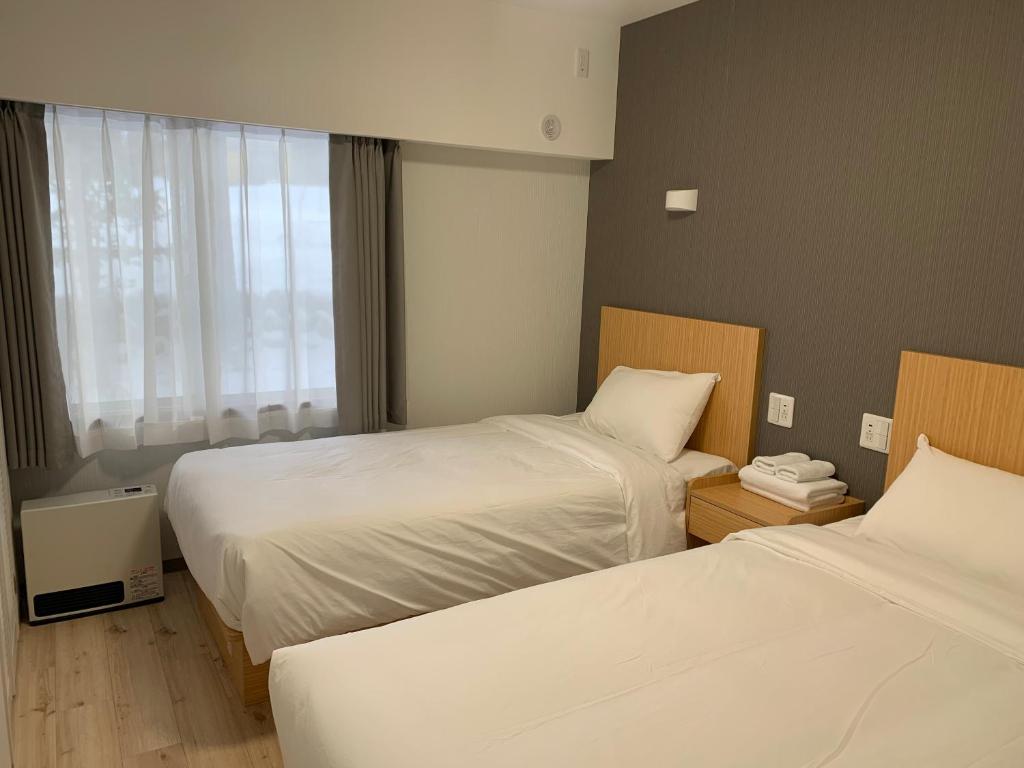 Postel nebo postele na pokoji v ubytování 軽井沢七福荘ホテル