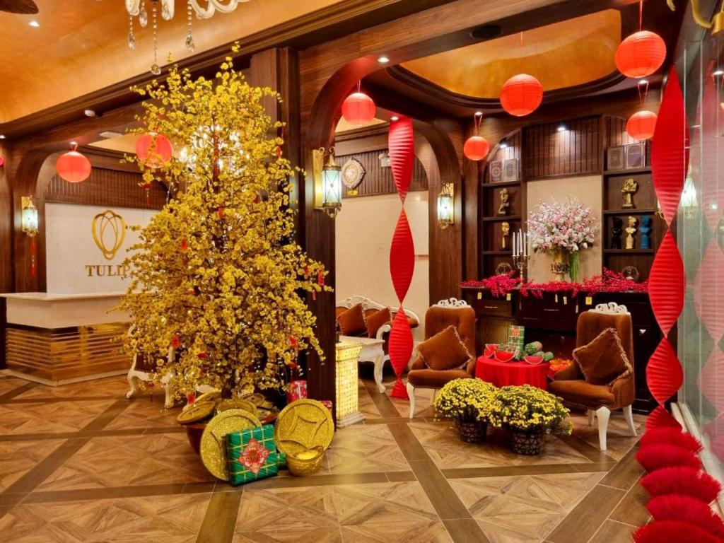 a lobby with a christmas tree in the middle at Tulip Hotel 3 in Da Lat