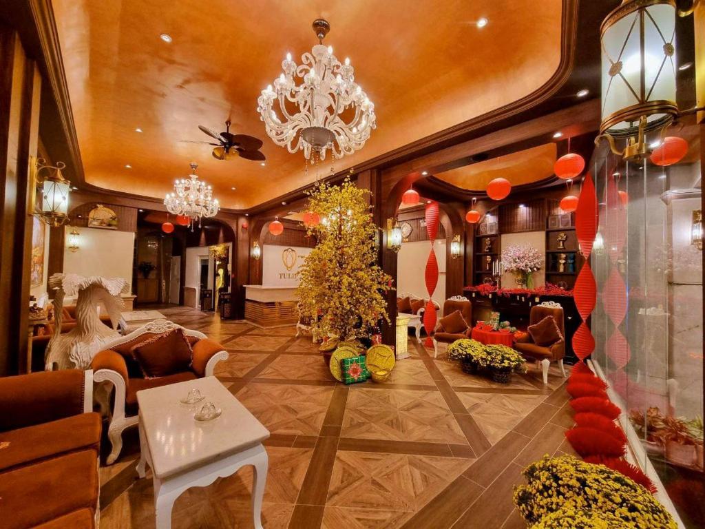 a lobby with couches and chairs and a chandelier at Tulip Hotel 3 in Da Lat