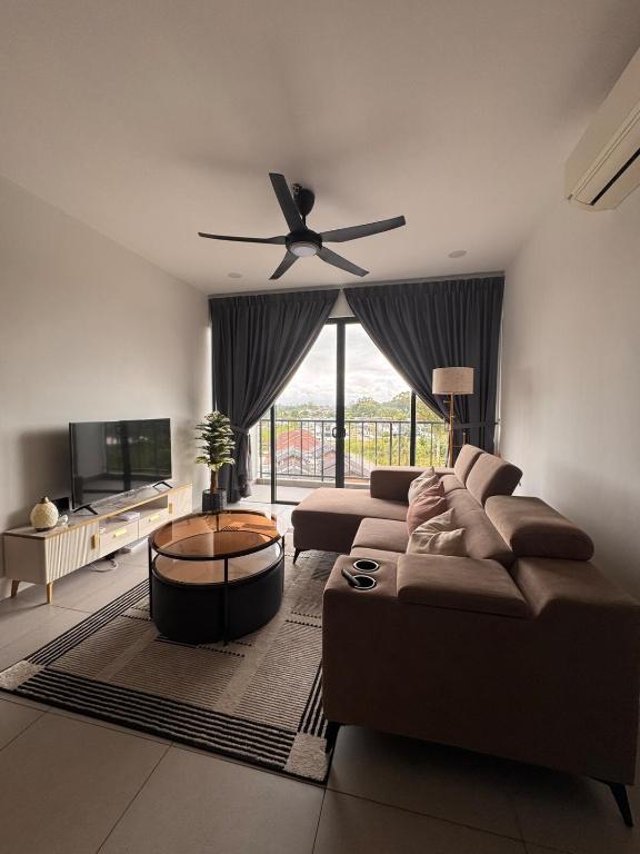 a living room with two couches and a ceiling fan at 2BR Apartment Near Kuching Airport in Kuching
