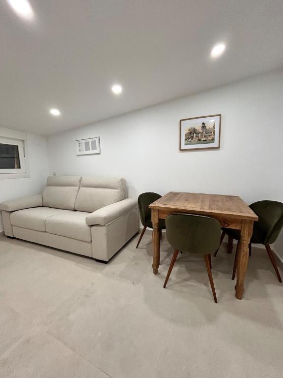 a living room with a couch and a table at AeroSuites202 Alojamiento Madrid in Madrid