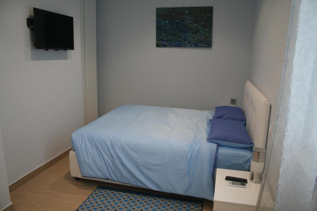 a small bedroom with a bed and a television at Sweet Monte Verde in Rome