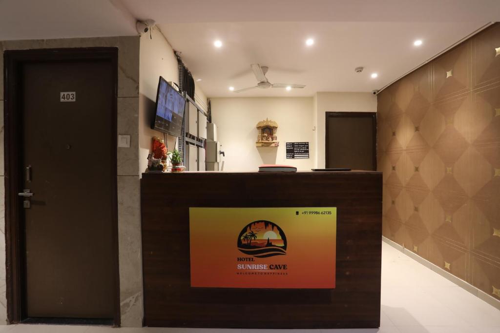 a lobby with a reception desk in a building at Sunrise cave in Surat