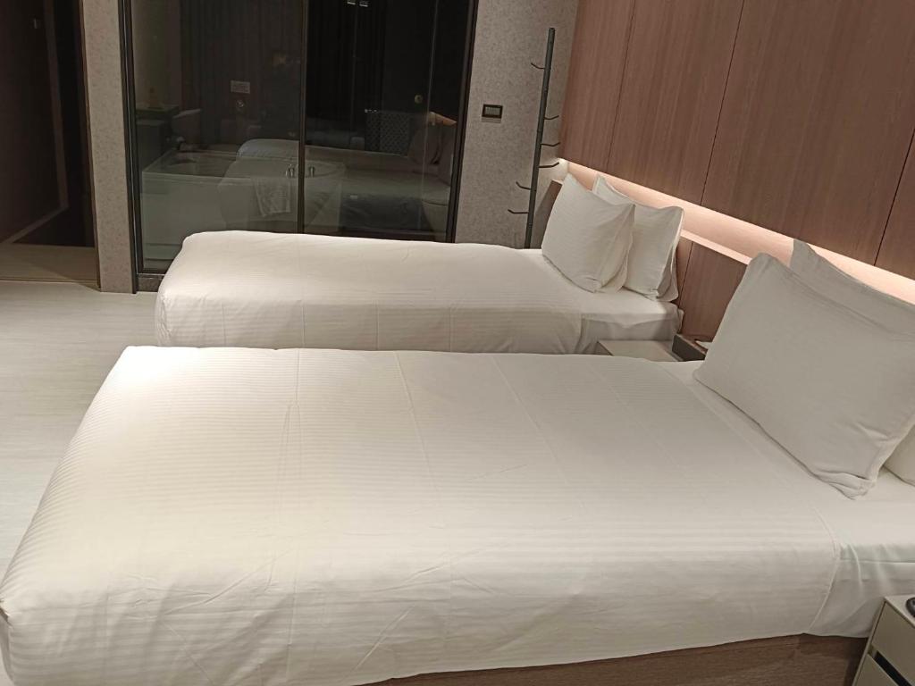 Postel nebo postele na pokoji v ubytování Jiati Business Motel