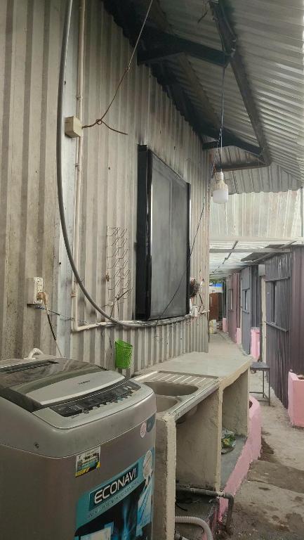 a room with a television on the wall of a building at Happy Farm Homestay in Ấp Long Ðại